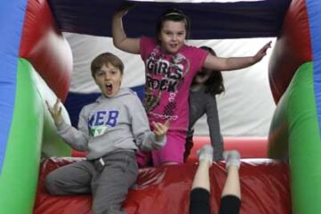 boy-and-girl-campers-on-bouncy-castle-slide