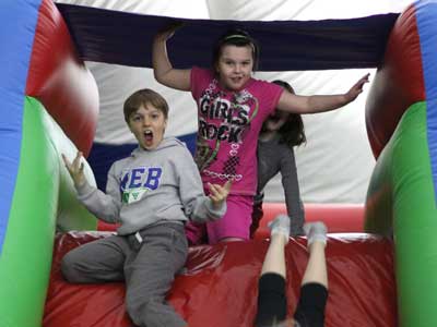 boy-and-girl-campers-on-bouncy-castle-slide