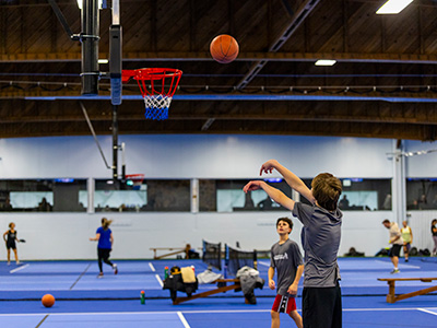 Kids shooting on a basketball net. New indoor courts