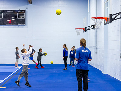 Group of engaged kids doing a basketball shooting game