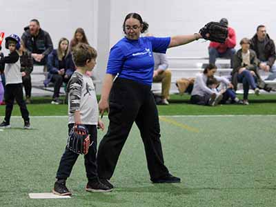 baseball coach teaching pitcher player