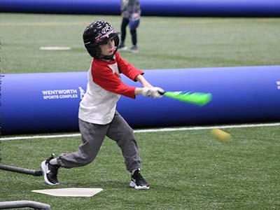 Youth baseball player swinging at pitches