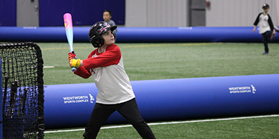 child ready to swing at the plate in little league game